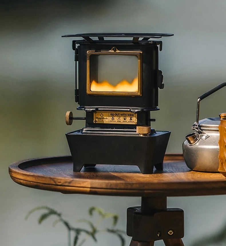 vintage black oil lamp on a wooden table next to a silver tea kettle ashtagoutdoors