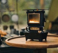 vintage black oil lamp on a wooden table outside at a campsite ashtagoutdoors 